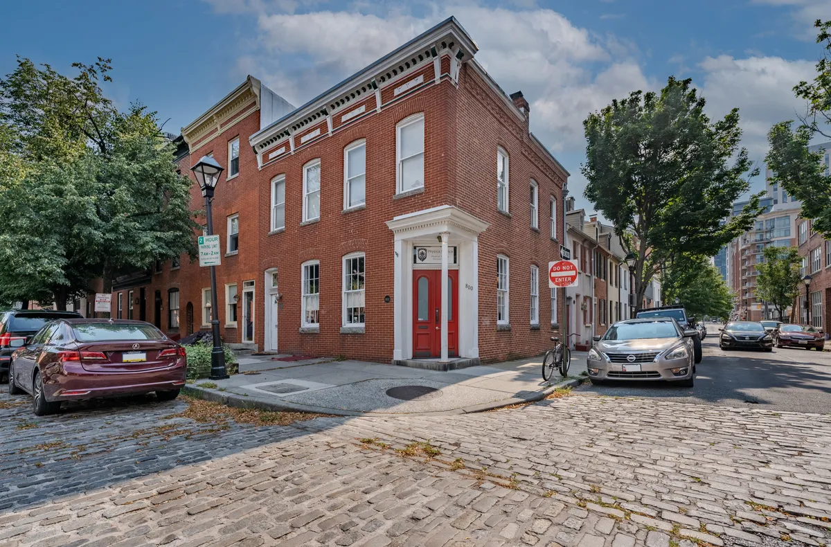 Historic brick building exterior in Fells Point, Baltimore, serving as the Physica Medica clinic location.