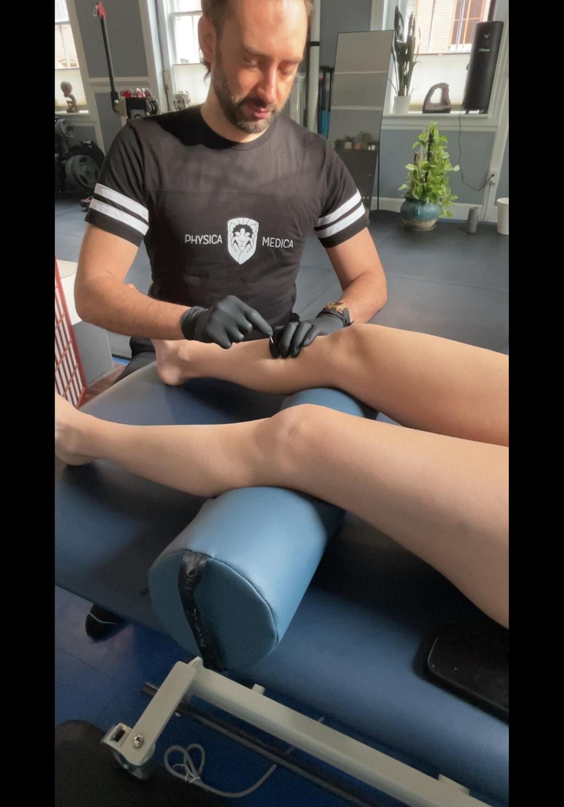 Physical therapist performing forearm and wrist palpation examination on a client